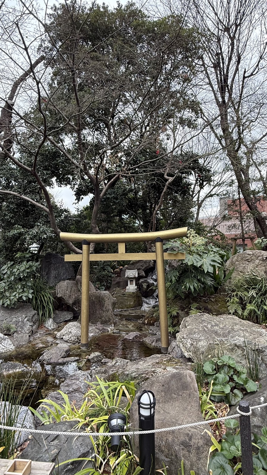 A small torii over a spring-fed pool on the grounds