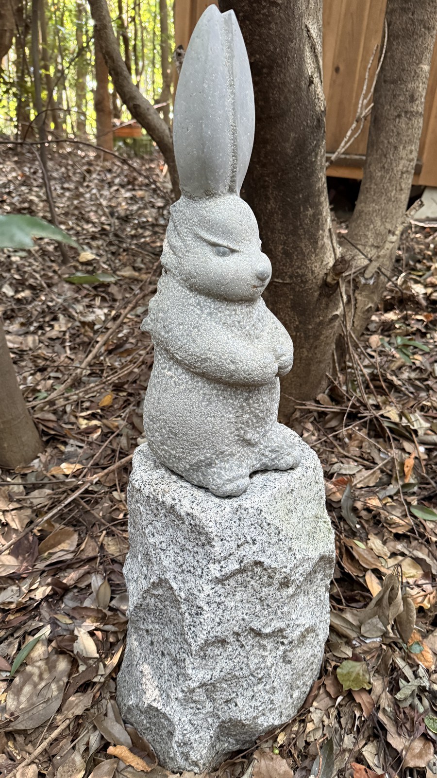 A stone statue of a standing rabbit