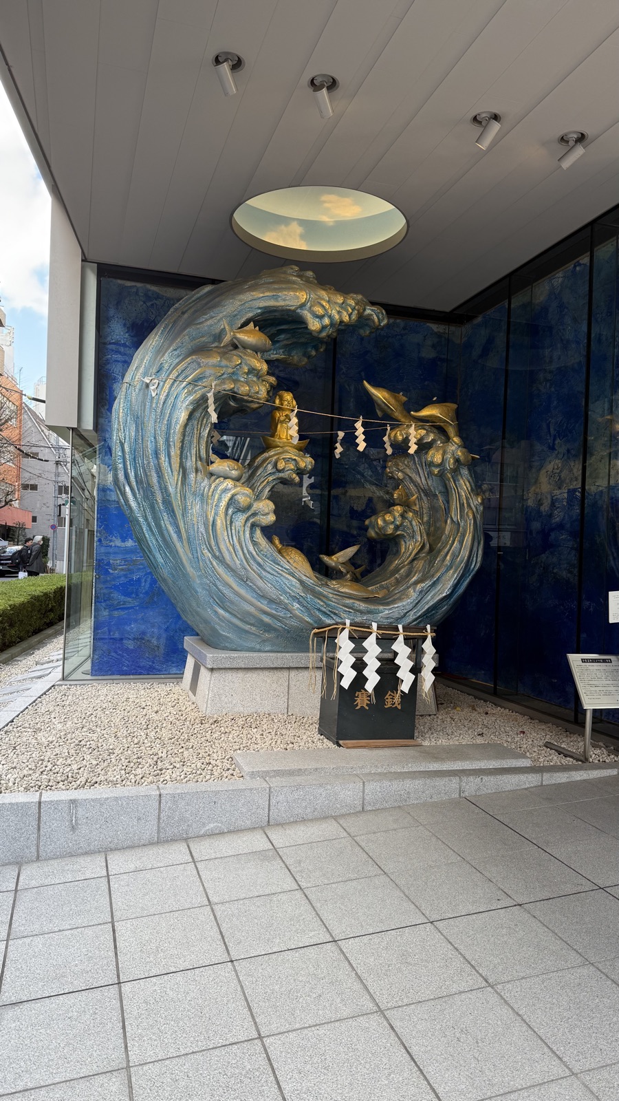 A gold object shaped like waves and a fish