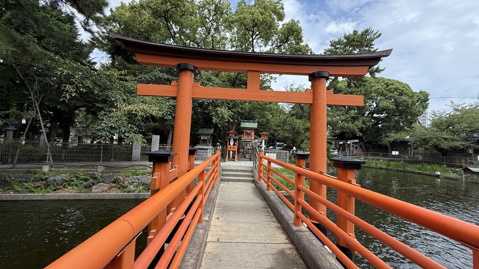 The vermilion bridge over the pond, and a torii