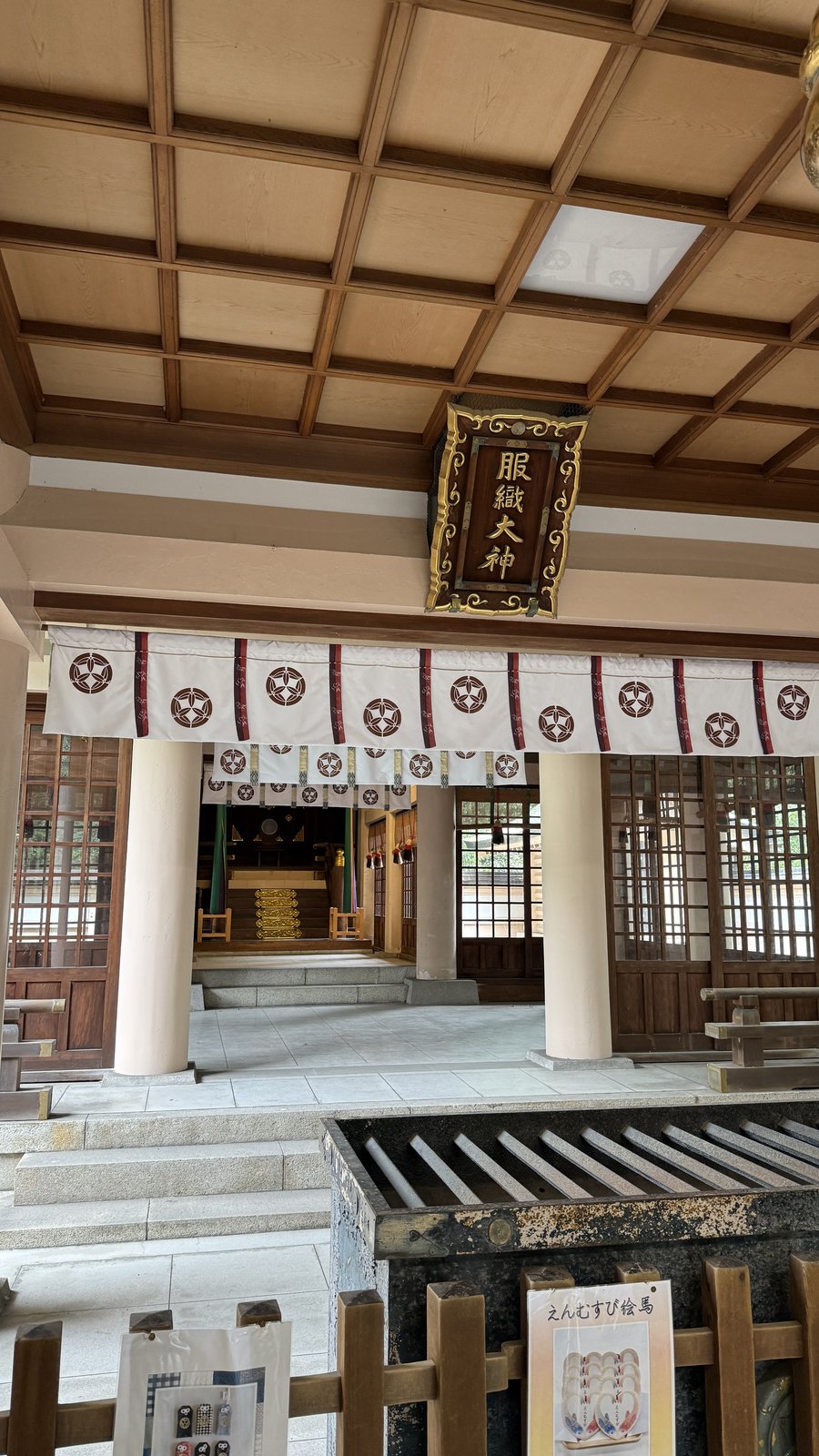 Under the eaves, with a plaque reading “Hatori Okami”