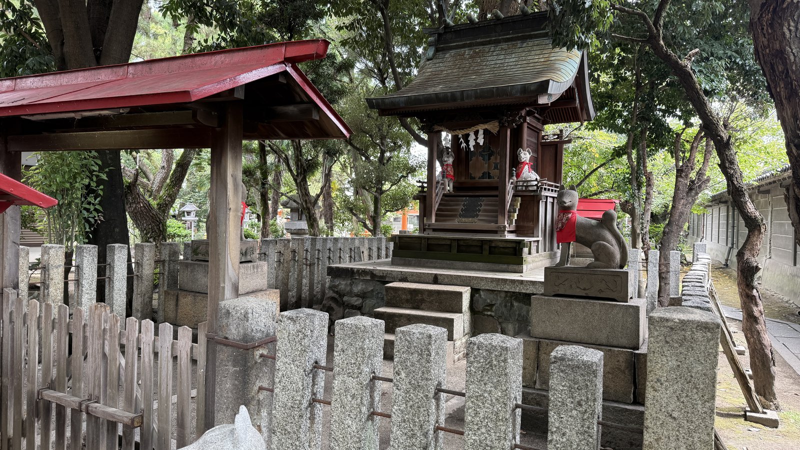 A small shrine in the grounds, with a fox statue