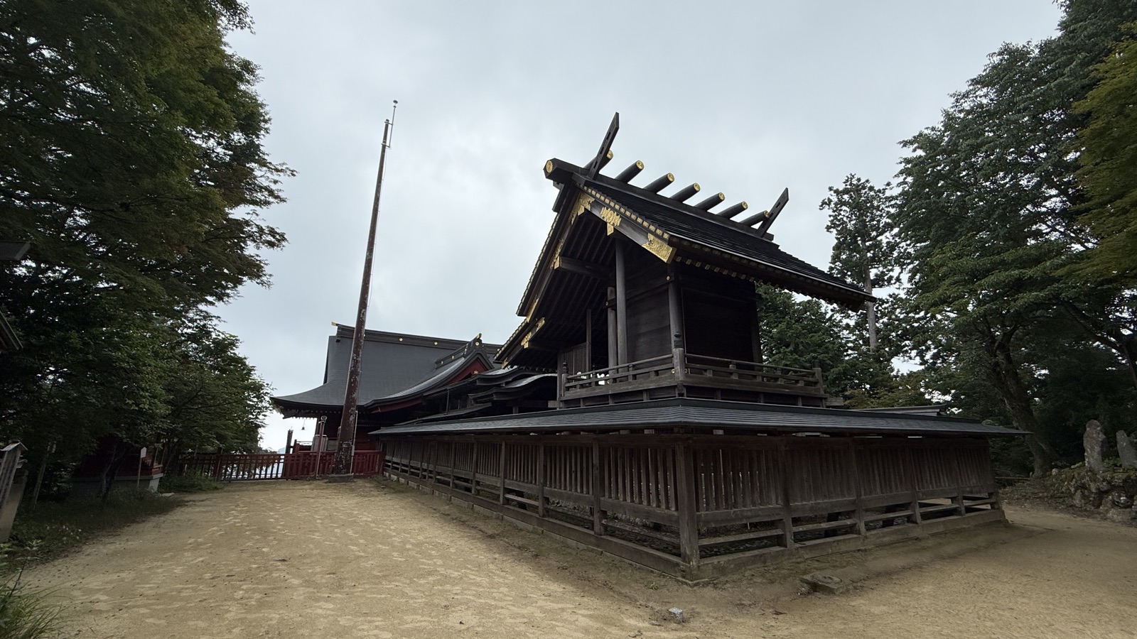 Black-and-gold shrine buildings seen from the side