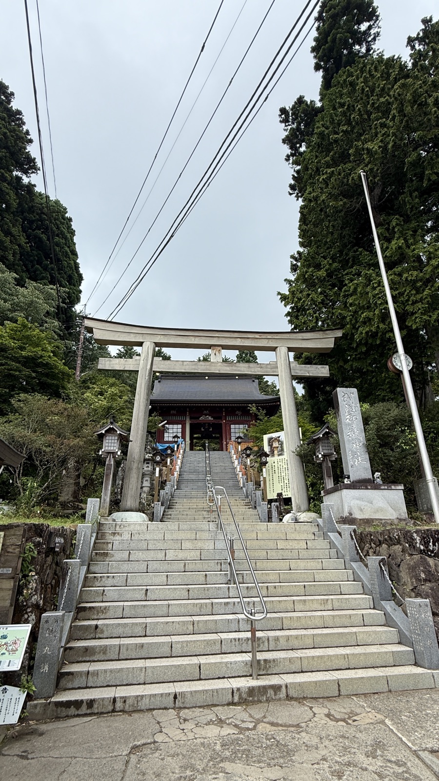 Shrine building seen beyond a torii and stone steps