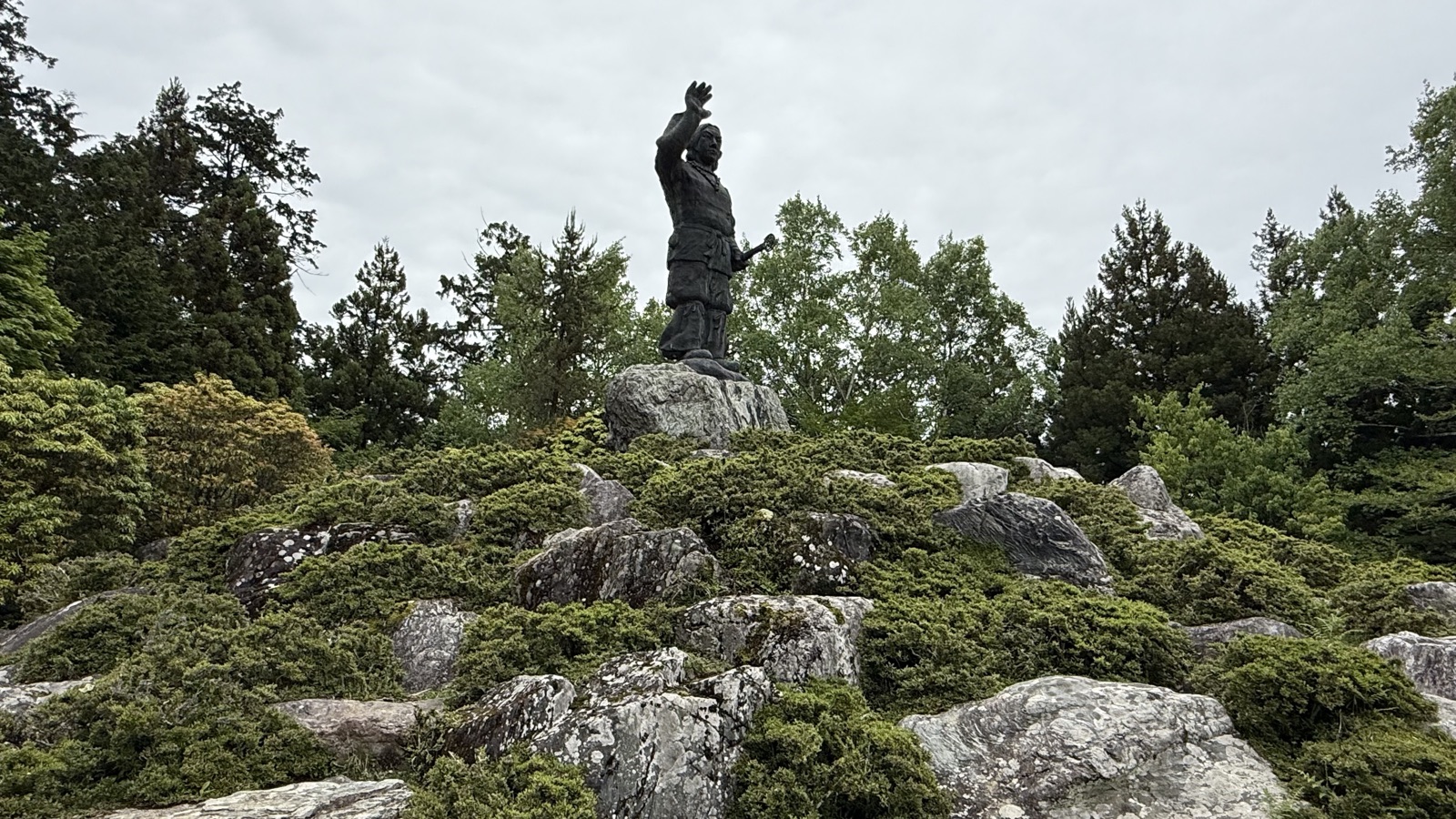 A human figure standing on a rocky summit