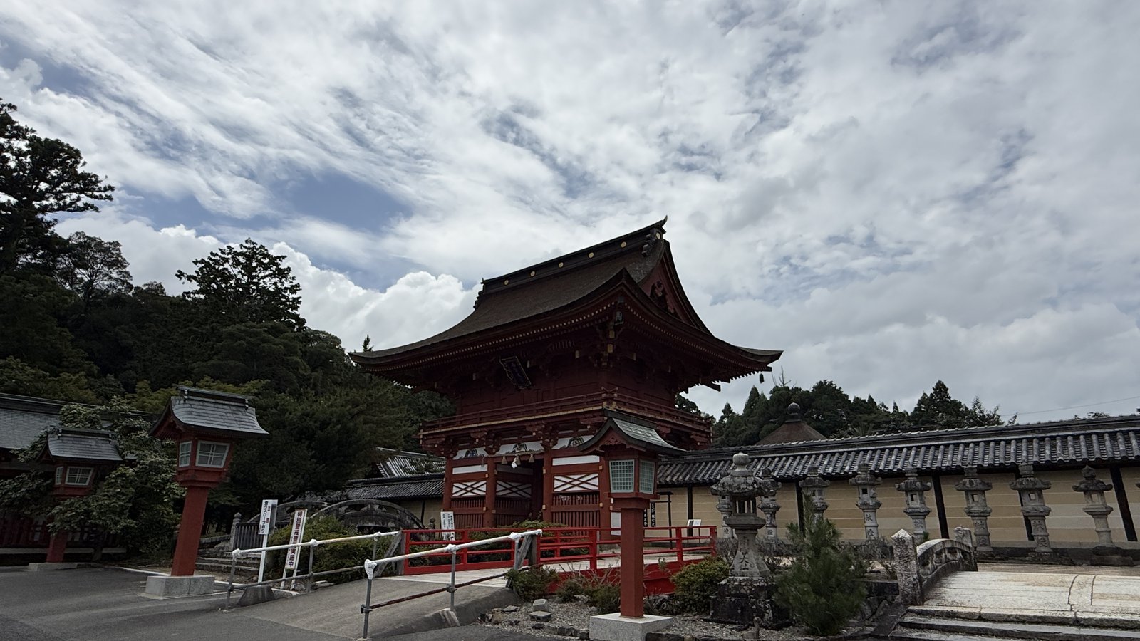 The vermilion two-storey gate, with the wall beside it