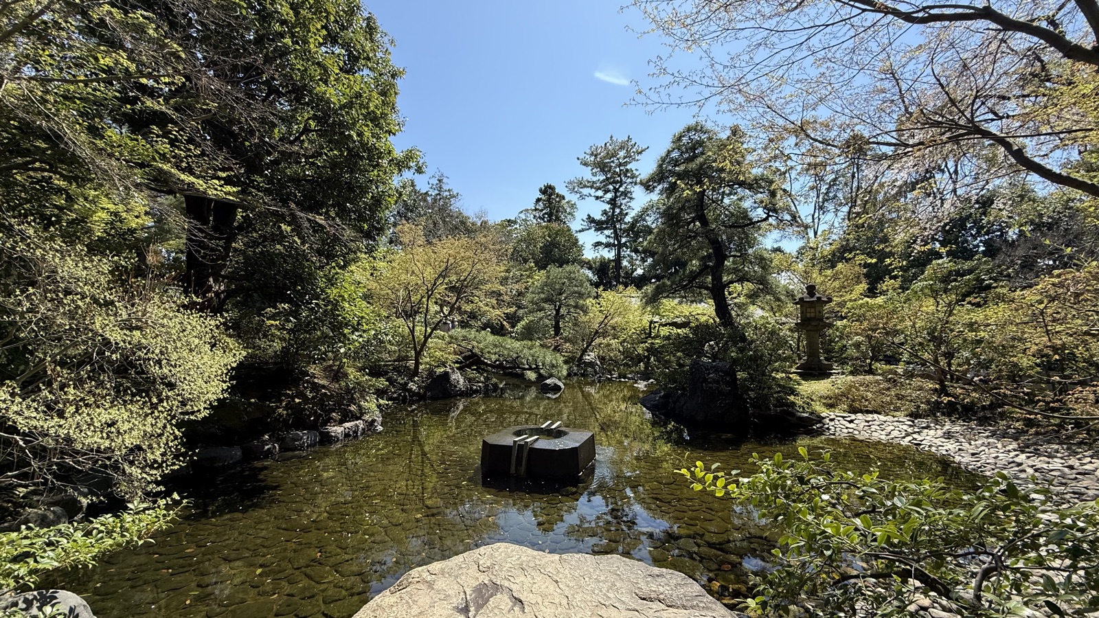 A well-frame motif floating in the garden pond